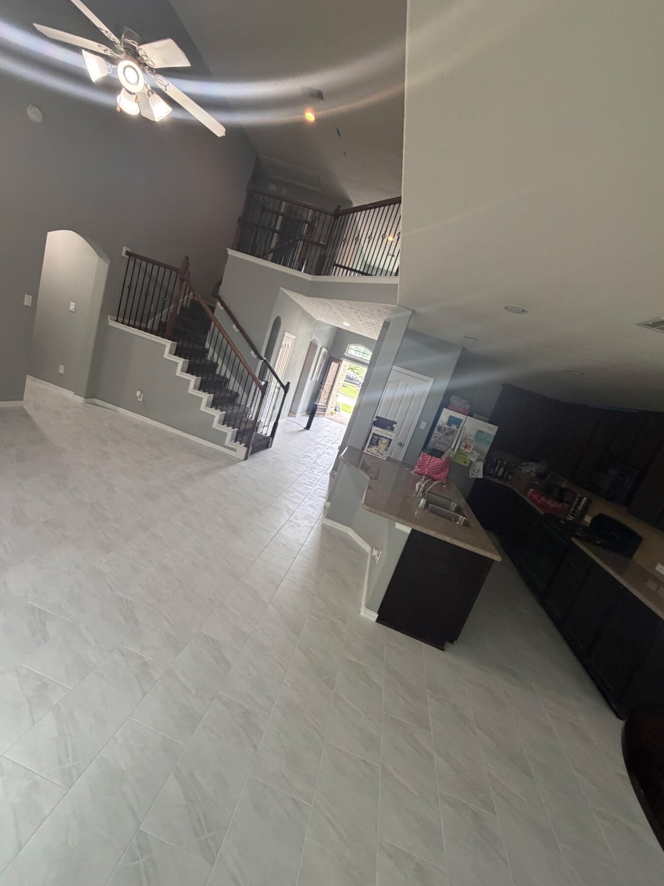 Spacious cleaned-out home interior with stairs and kitchen